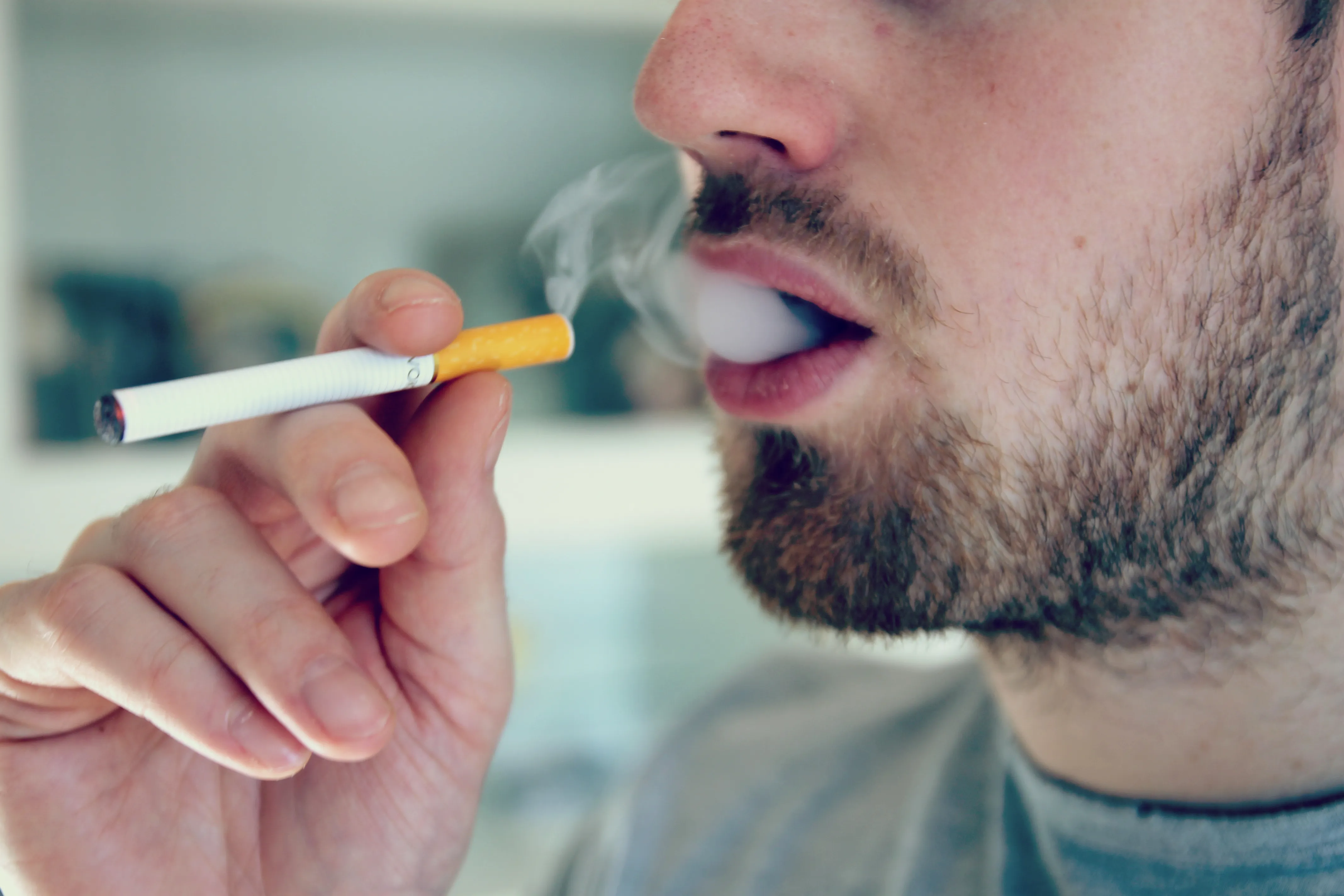 Man smoking a cigarette, picturing unhealthy habits that harm the health of the church body