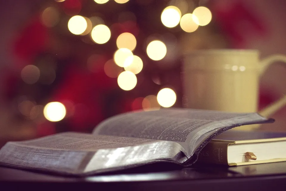 Open Bible on a table among warm glowing lights, for a study of biblical inerrancy
