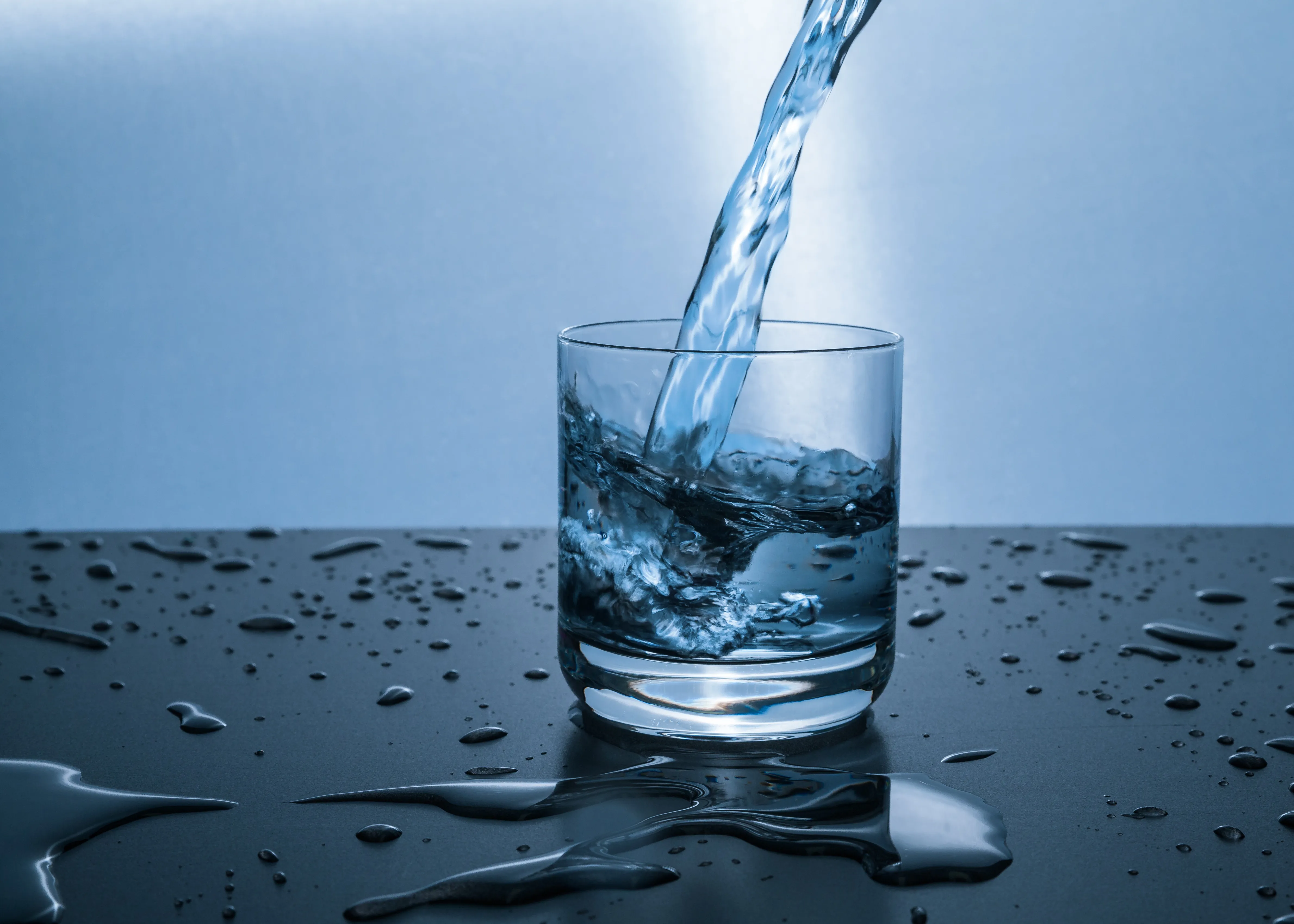 Water pouring into a glass, illustrating the cup of cold water in Matthew 10:42