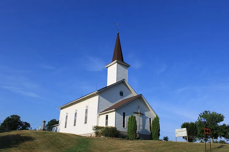 White country church with a steeple, for a study of tithing and giving in the New Testament
