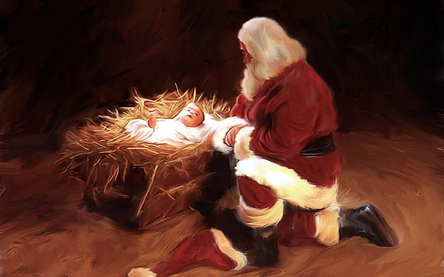 Santa Claus kneeling before baby Jesus