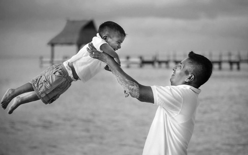 Child shows faith in his dad who is carrying him